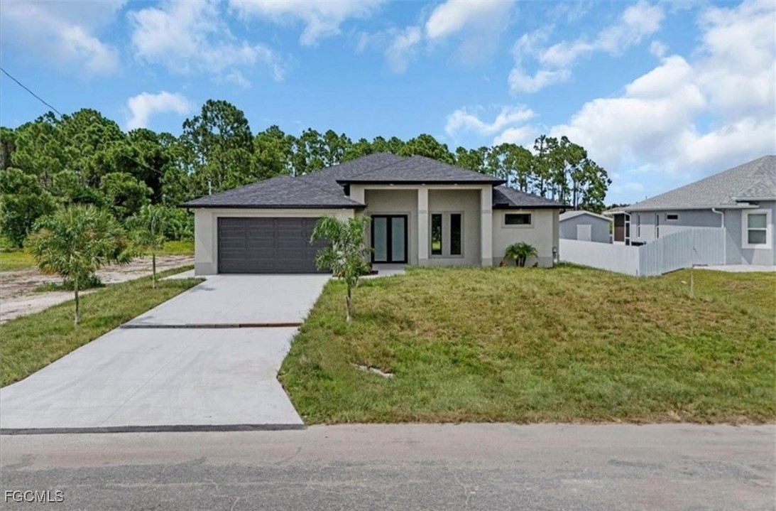 3208 3rd Street Southwest Lehigh Acres, FL 33976 - Photo 2 of 31 front view of a house with a yard