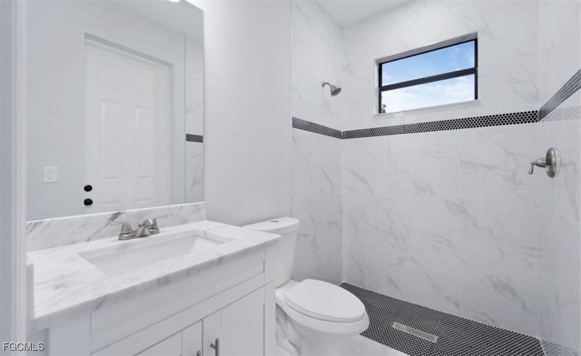 3208 3rd Street Southwest Lehigh Acres, FL 33976 - Photo 25 of 31 a bathroom with a sink toilet and vanity