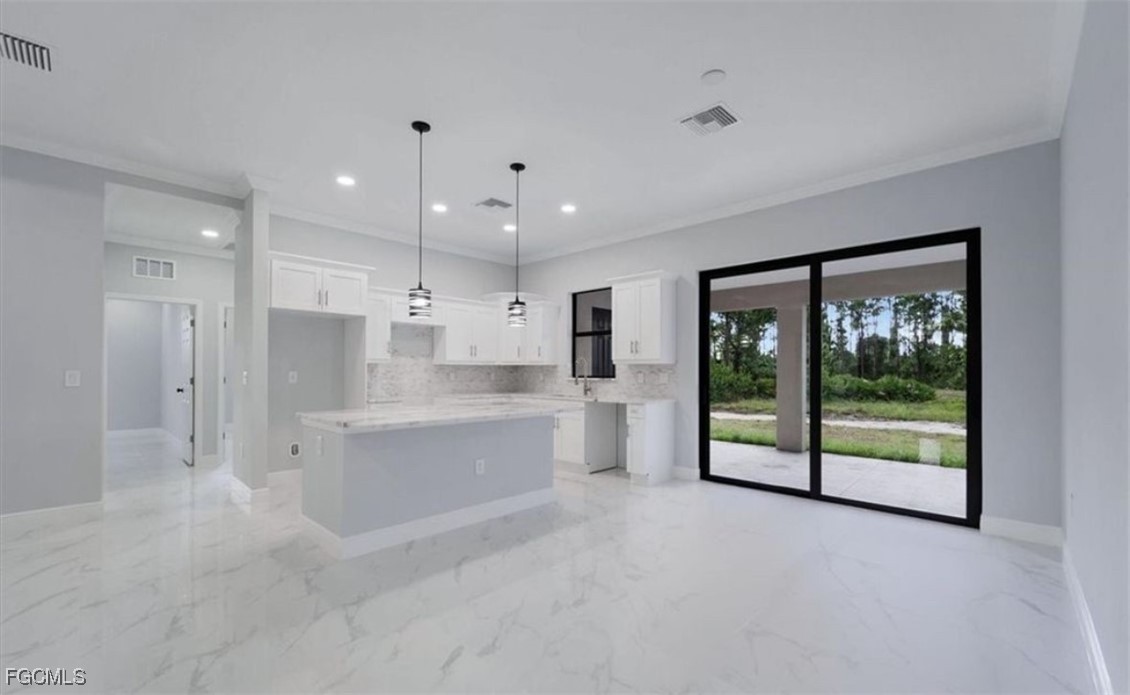 3208 3rd Street Southwest Lehigh Acres, FL 33976 - Photo 27 of 31 a large white kitchen with large windows and refrigerator