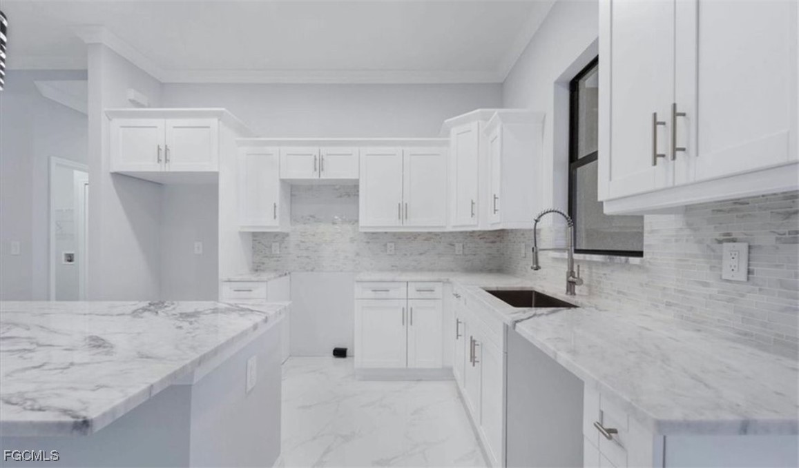3208 3rd Street Southwest Lehigh Acres, FL 33976 - Photo 28 of 31 a kitchen with a sink stove and cabinets