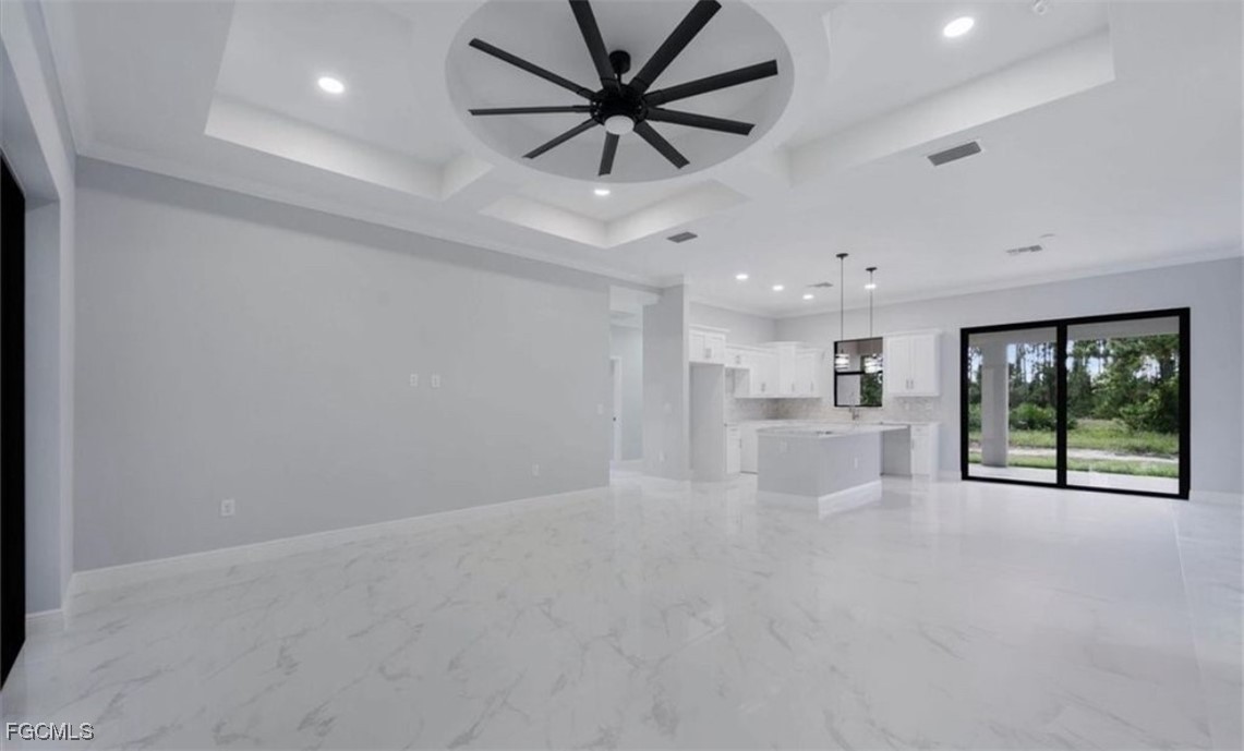 3208 3rd Street Southwest Lehigh Acres, FL 33976 - Photo 6 of 31 a view of a livingroom with a kitchen and a window