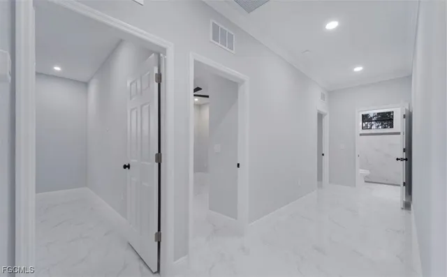 an empty room with a ceiling fan and carpet