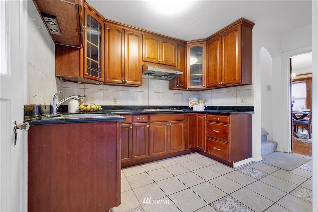 1433 South Hinds Street Seattle, WA 98144 - Photo 13 of 40 a kitchen with stainless steel appliances granite countertop a refrigerator and a stove top oven