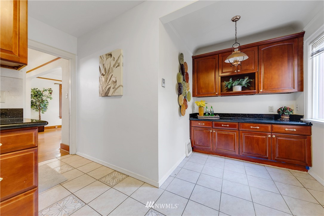 1433 South Hinds Street Seattle, WA 98144 - Photo 14 of 40 a kitchen with stainless steel appliances granite countertop a refrigerator and a stove top oven