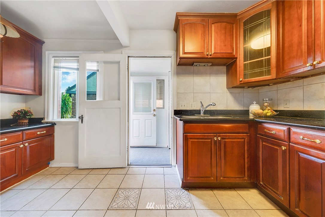 1433 South Hinds Street Seattle, WA 98144 - Photo 16 of 40 a kitchen with stainless steel appliances granite countertop a refrigerator and a sink