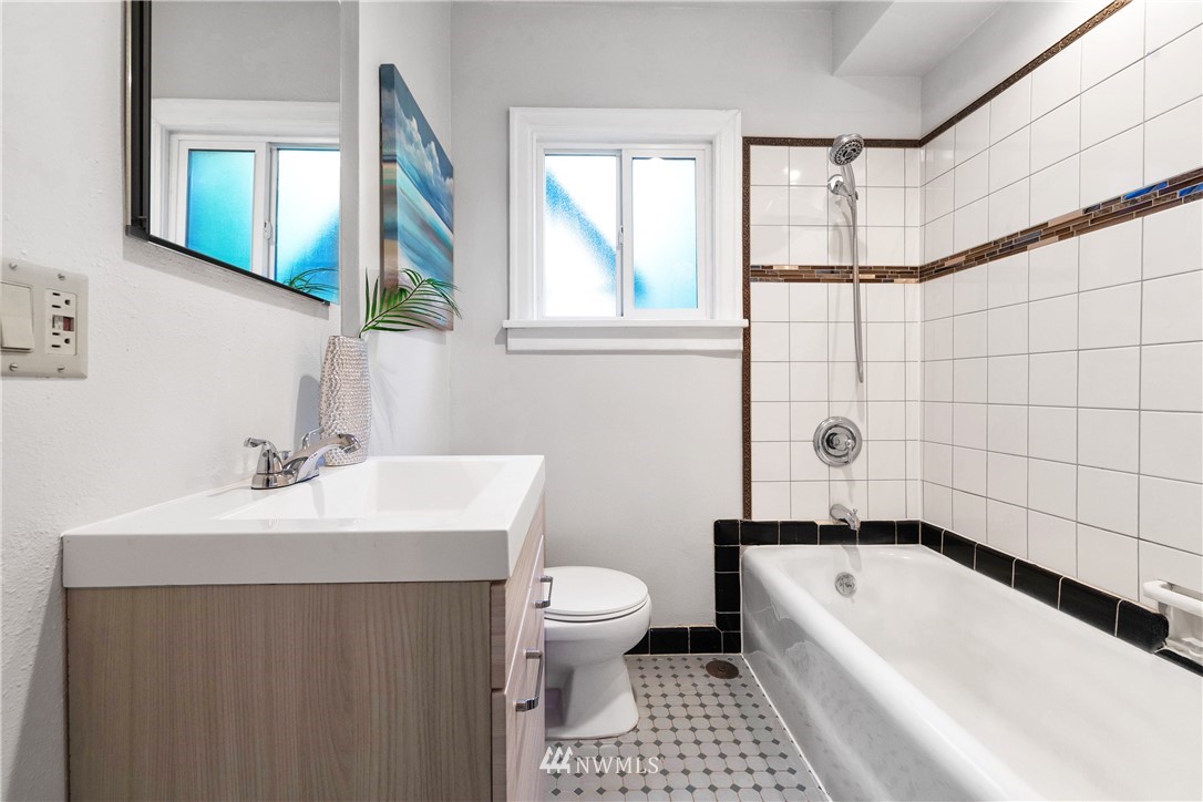 1433 South Hinds Street Seattle, WA 98144 - Photo 3 of 40 a bathroom with a sink a toilet and shower
