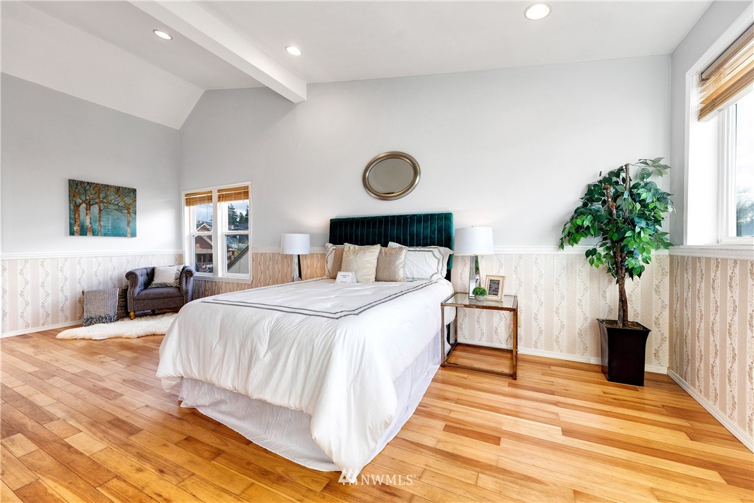1433 South Hinds Street Seattle, WA 98144 - Photo 23 of 40 a bedroom with a large bed and a potted plant