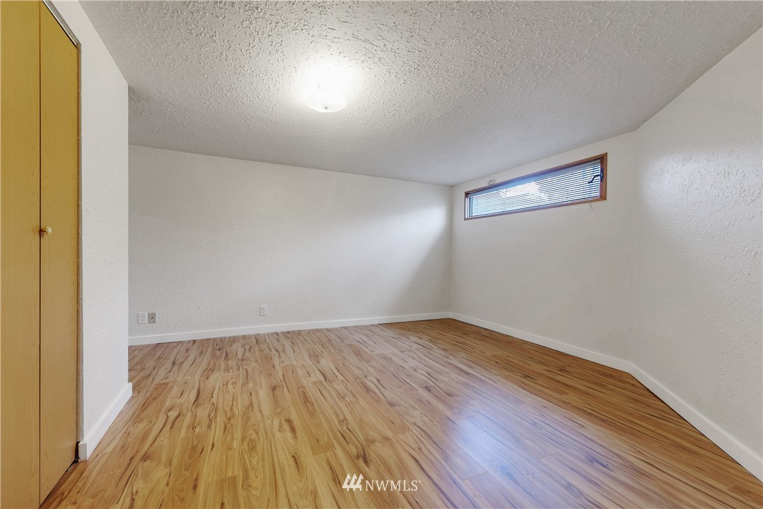 1433 South Hinds Street Seattle, WA 98144 - Photo 29 of 40 a view of an empty room with wooden floor