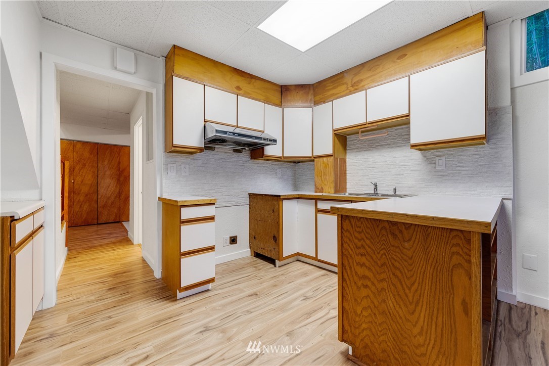 1433 South Hinds Street Seattle, WA 98144 - Photo 32 of 40 a kitchen with wooden floors and cabinets