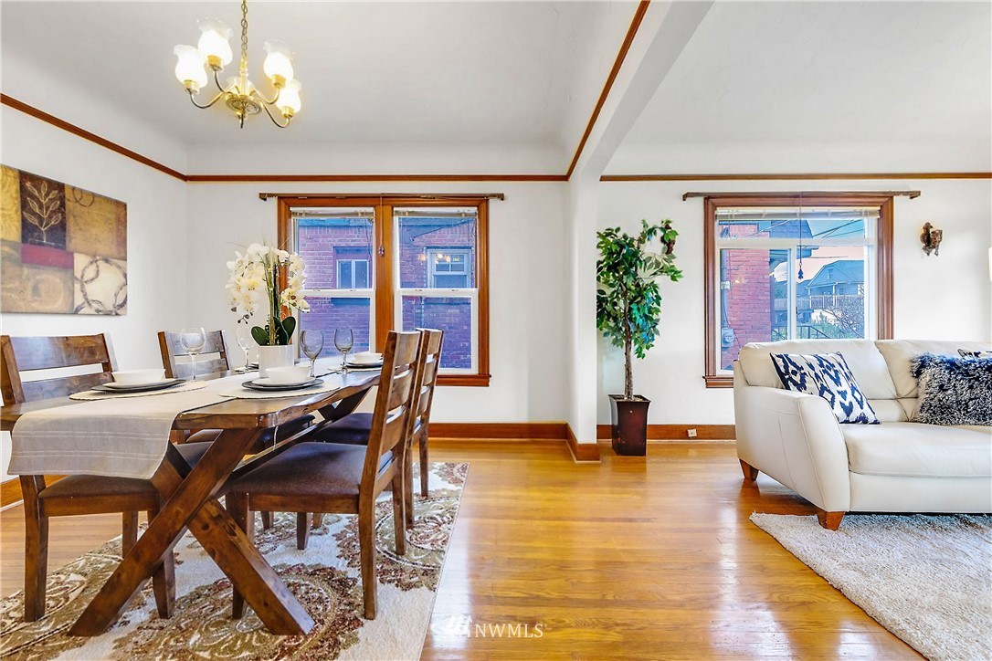 1433 South Hinds Street Seattle, WA 98144 - Photo 8 of 40 a living room with furniture a dining table and a chandelier