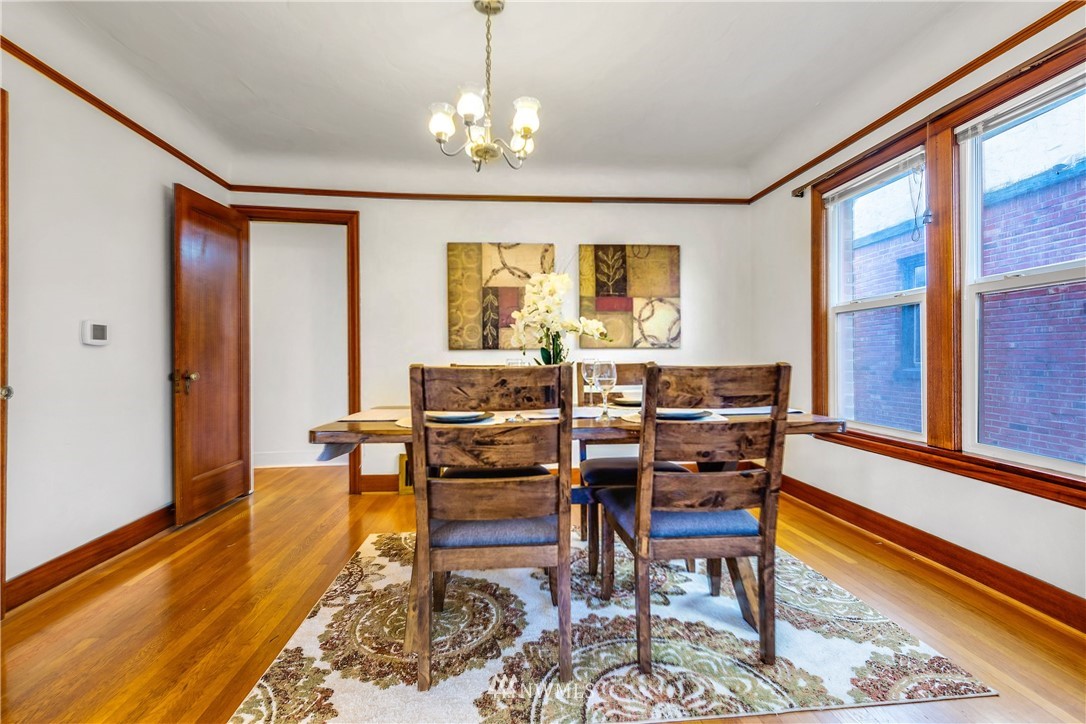 1433 South Hinds Street Seattle, WA 98144 - Photo 10 of 40 a dining room with furniture a rug and a chandelier