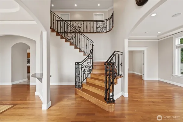 a view of entryway and hall with wooden floor