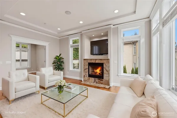 a living room with furniture a flat screen tv and a fireplace