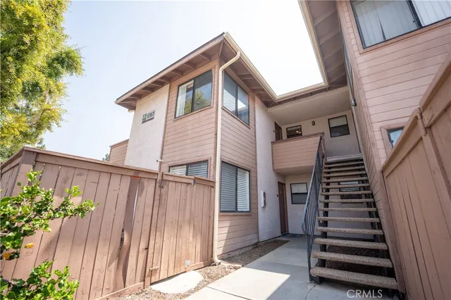 a view of a house with wooden wall and windows