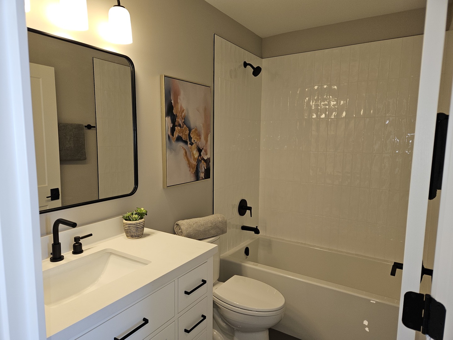 183 Pointe Drive, Unit 183 Northbrook, IL 60062 - Photo 14 of 15 a bathroom with a sink a toilet and shower