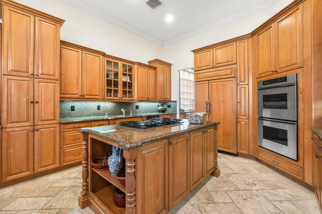 a kitchen with stainless steel appliances granite countertop a stove and a refrigerator