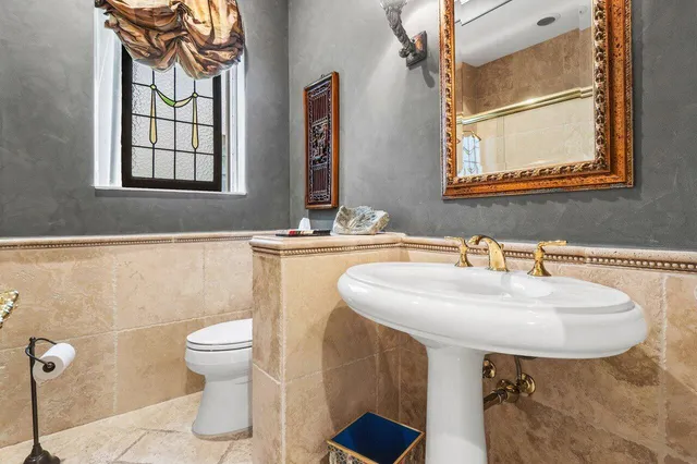 a bathroom with a sink a toilet and mirror