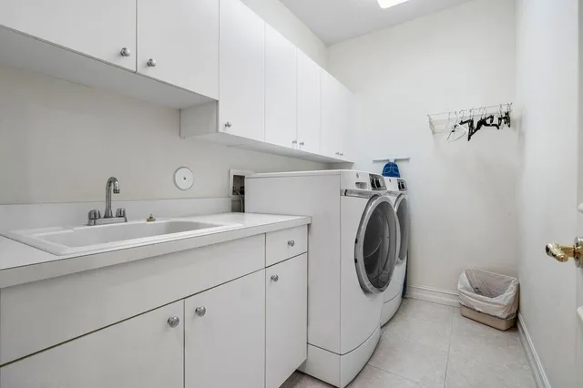 a utility room with sink dryer and washer