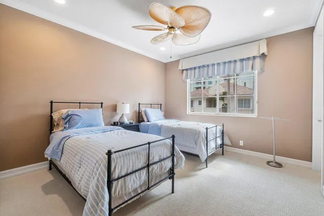 a bedroom with two beds and window