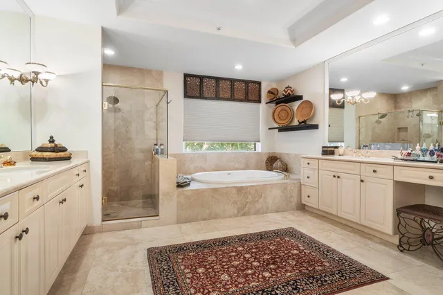 a bathroom with a double vanity sink a mirror a bathtub and shower