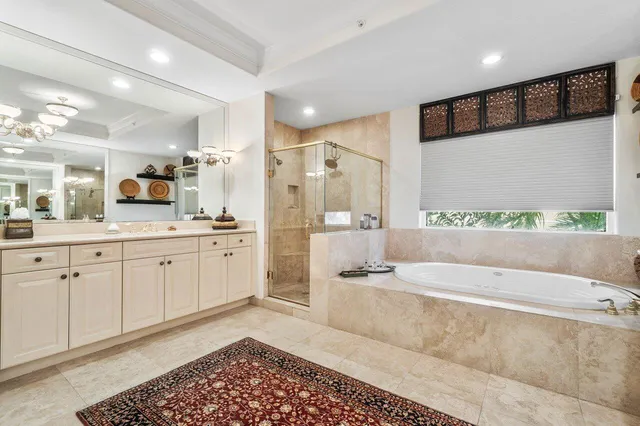 a spacious bathroom with a large tub shower and sink