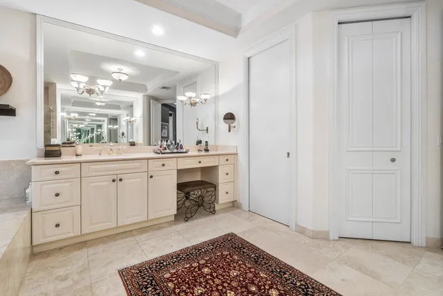 a spacious bathroom with a double vanity sink a mirror and a