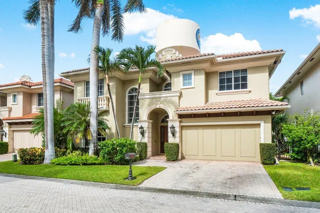 a front view of a house with a garden and plants