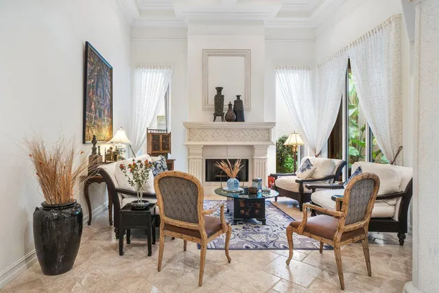 a living room with furniture fireplace and window