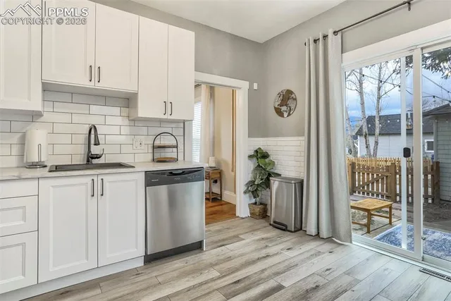 a kitchen with a refrigerator and a sink