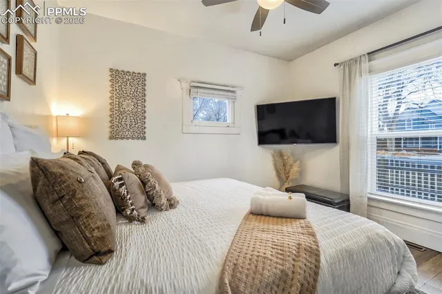 a bedroom with a bed and a flat screen tv