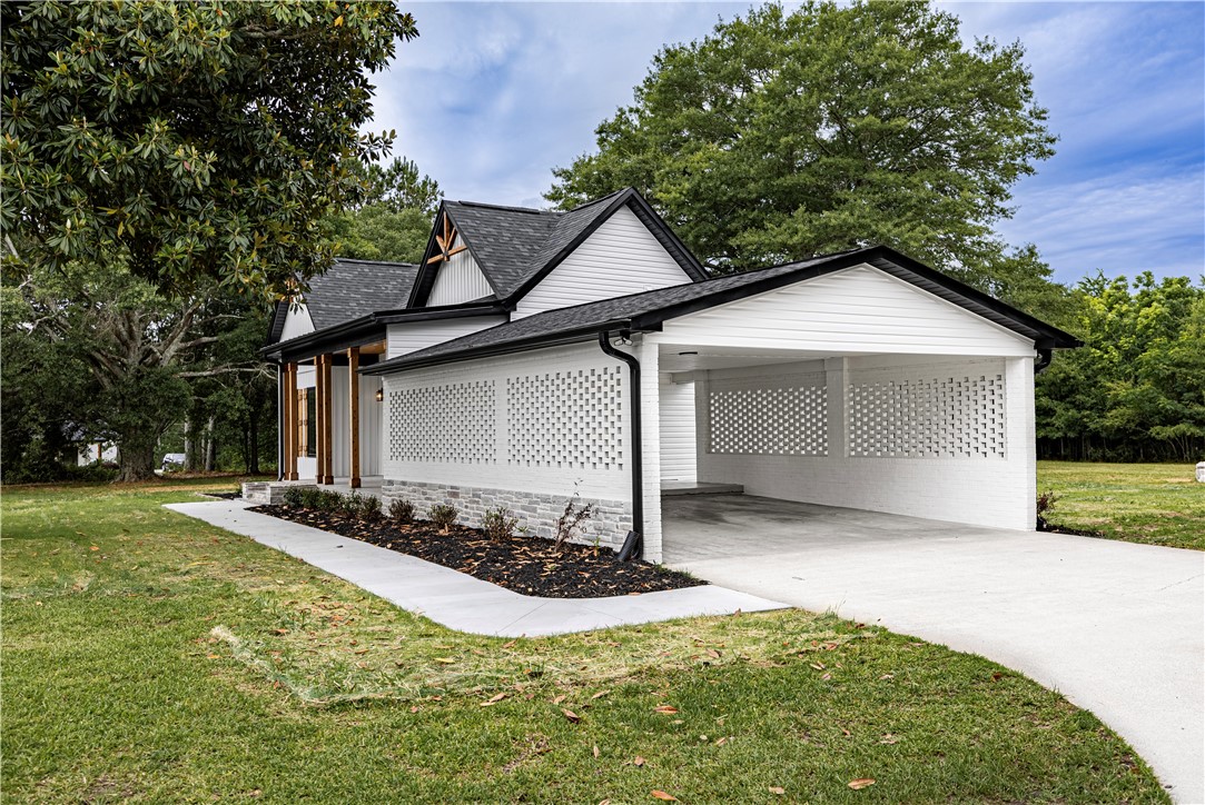 2817 Broadway Lake Road Anderson, SC 29621 - Photo 10 of 41 A striking modern farmhouse with an integrated carport offers stylish, convenient living.