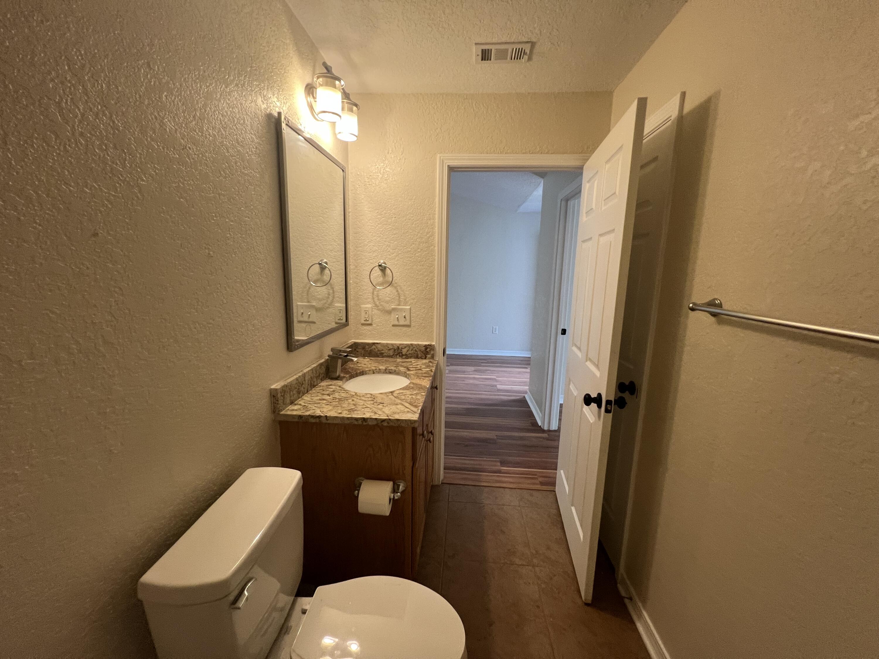 2864 Shoffner Avenue Crestview, FL 32539 - Photo 14 of 29 a bathroom with a toilet sink and mirror