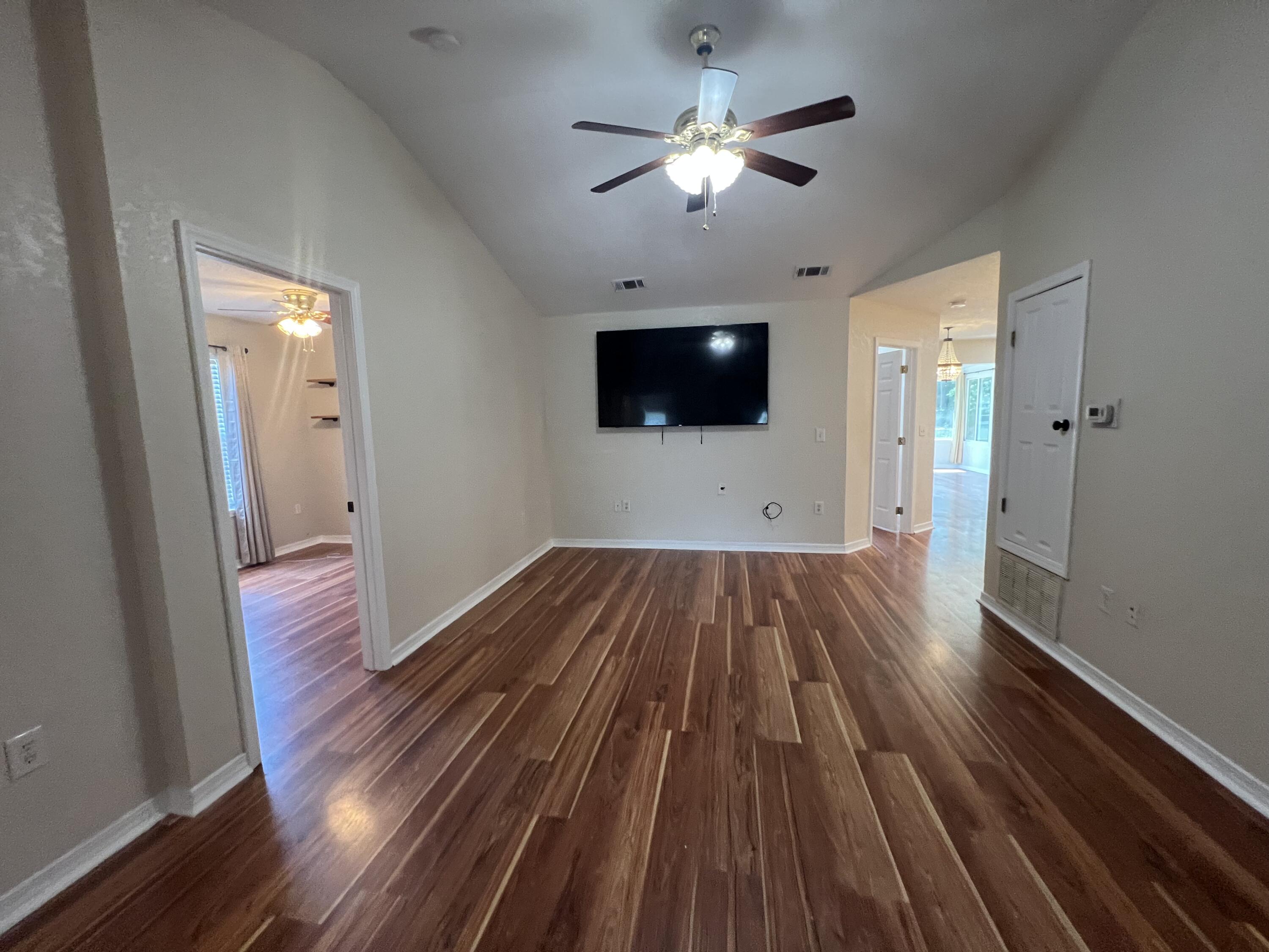 2864 Shoffner Avenue Crestview, FL 32539 - Photo 2 of 29 a view of a livingroom with wooden floor and a ceiling fan