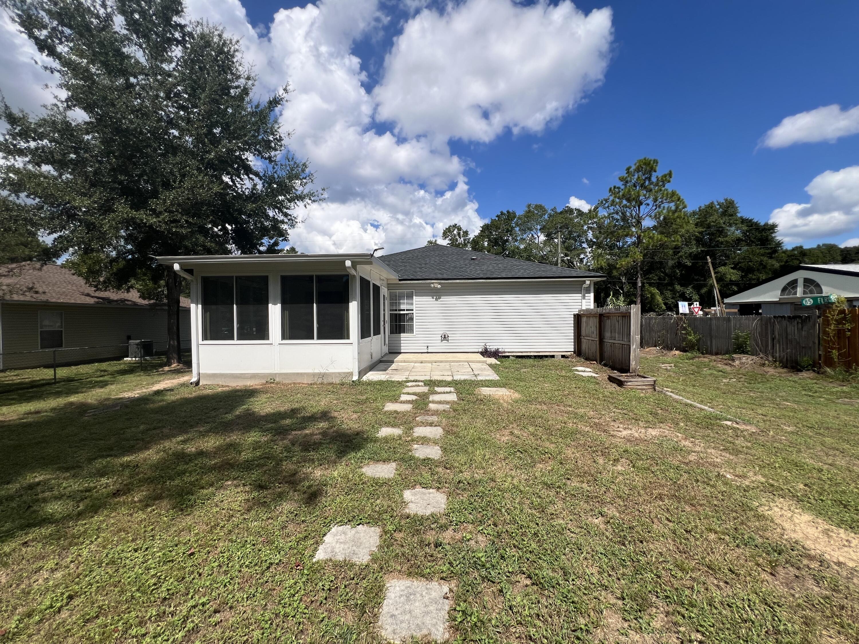 2864 Shoffner Avenue Crestview, FL 32539 - Photo 25 of 29 a view of a white house with a yard and a large tree
