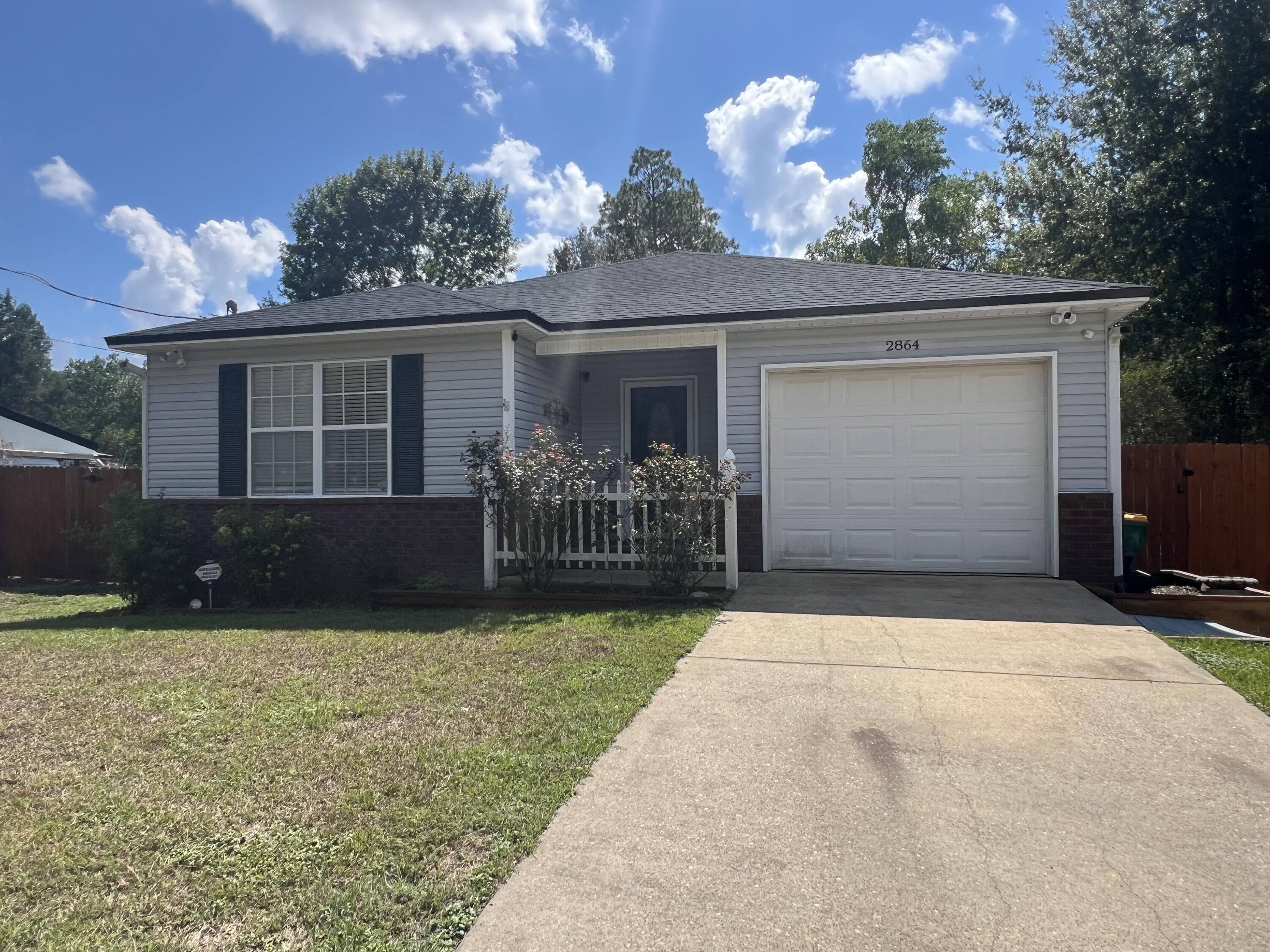 2864 Shoffner Avenue Crestview, FL 32539 - Photo 29 of 29 a front view of house with yard and trees in the background