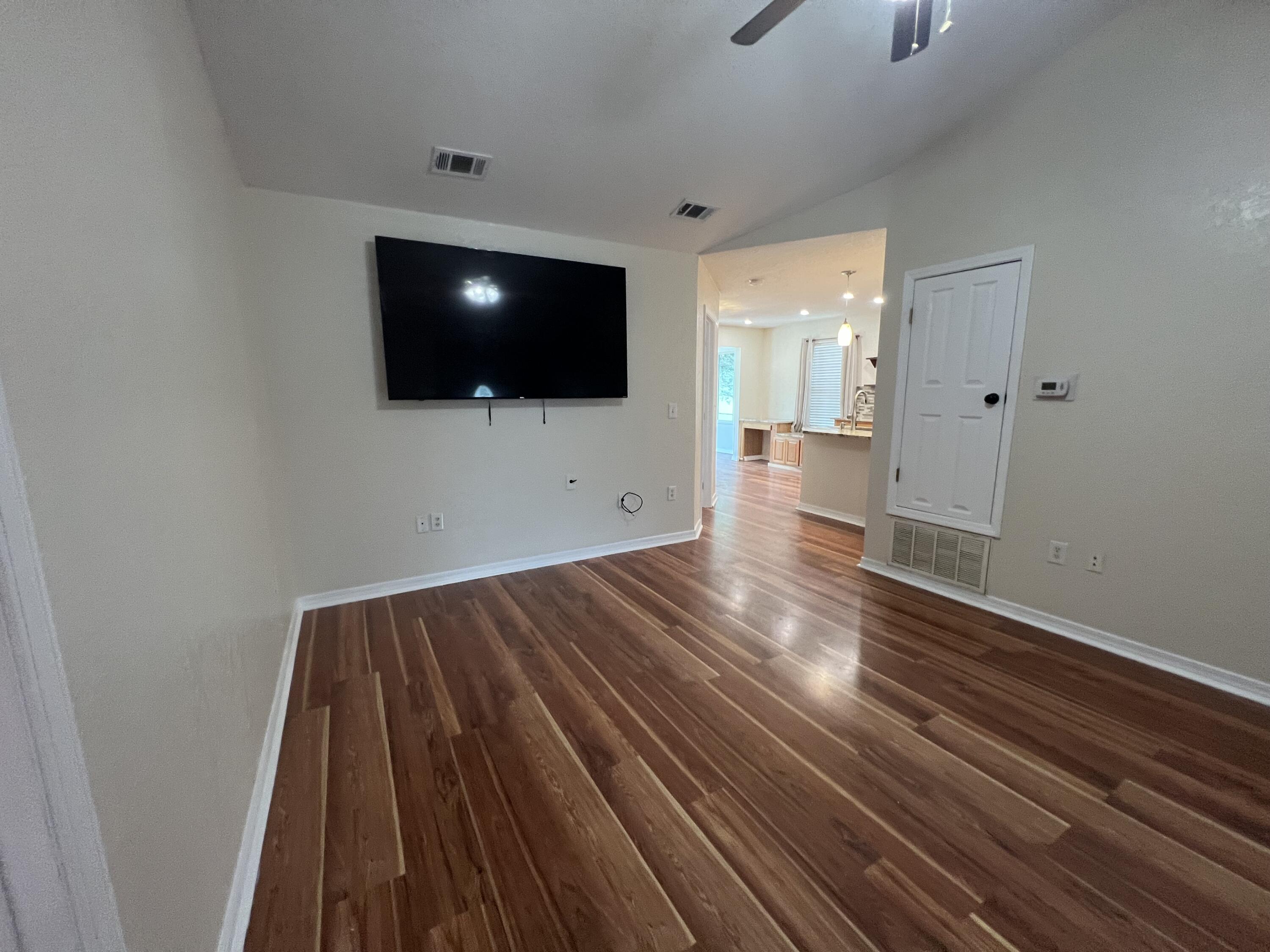 2864 Shoffner Avenue Crestview, FL 32539 - Photo 3 of 29 an empty room with wooden floor and windows