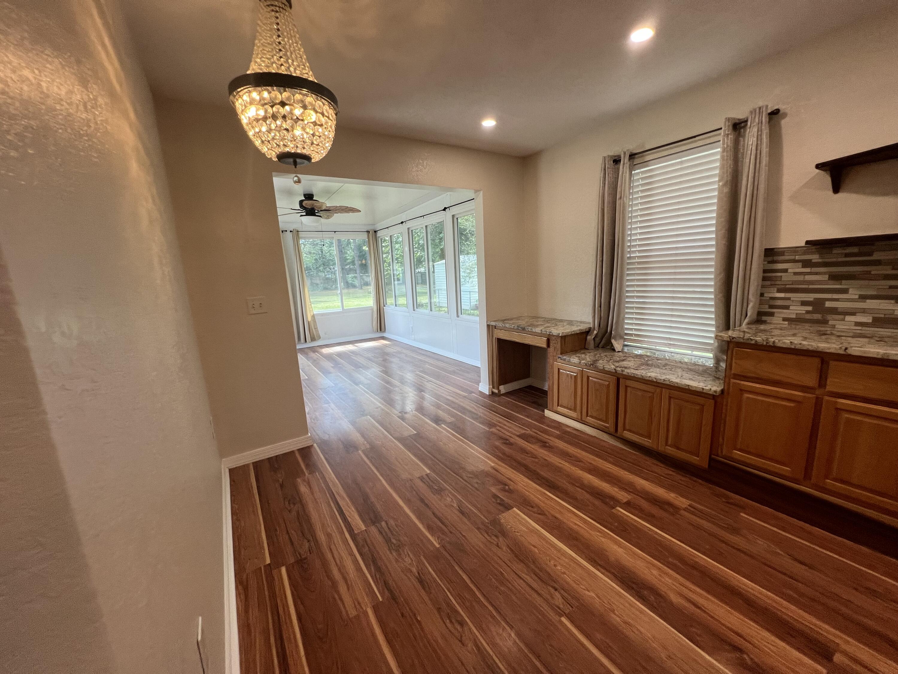 2864 Shoffner Avenue Crestview, FL 32539 - Photo 6 of 29 a view of a room with wooden floor and chandelier