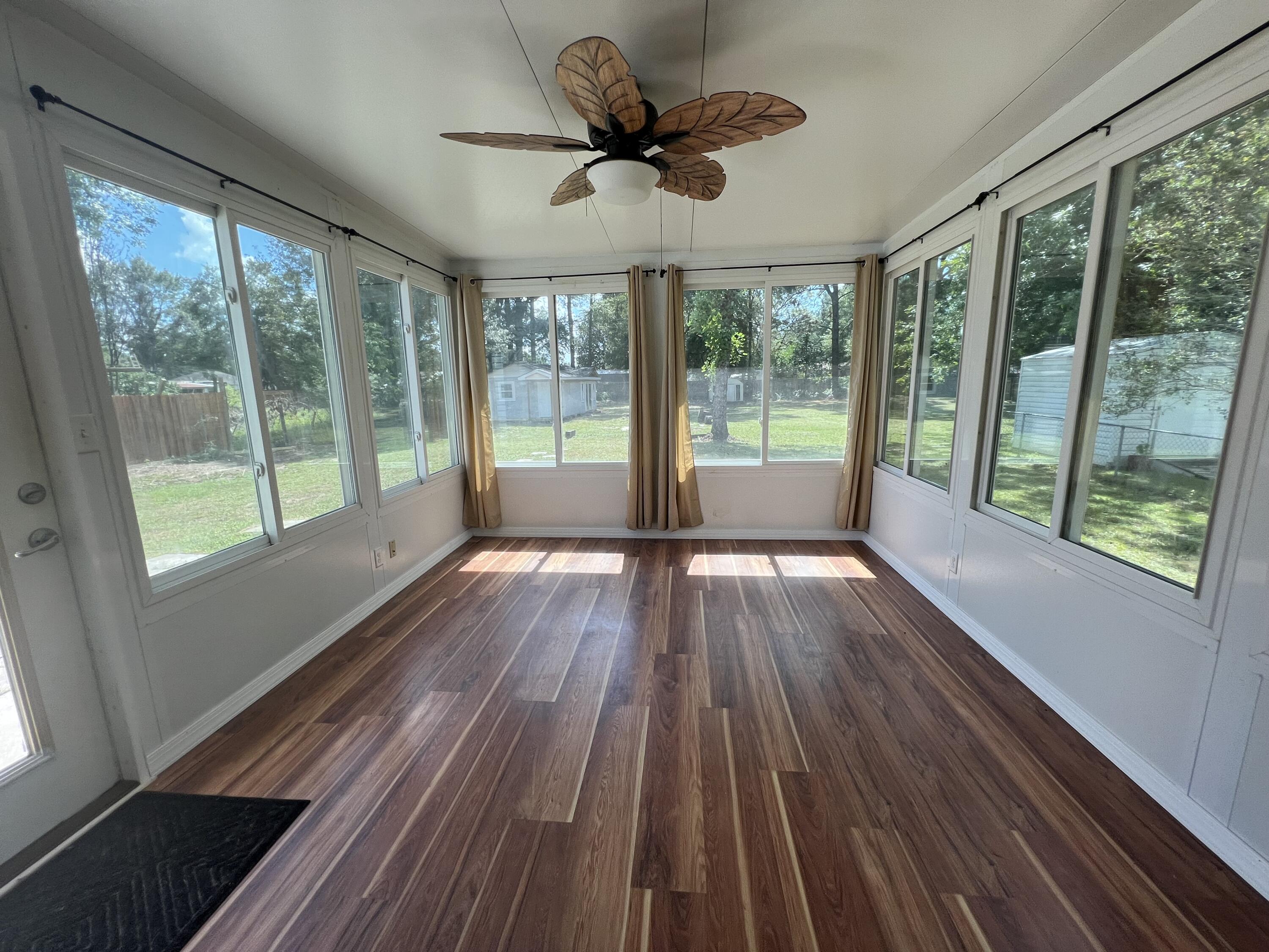 2864 Shoffner Avenue Crestview, FL 32539 - Photo 8 of 29 a view of empty room with wooden floor and fan