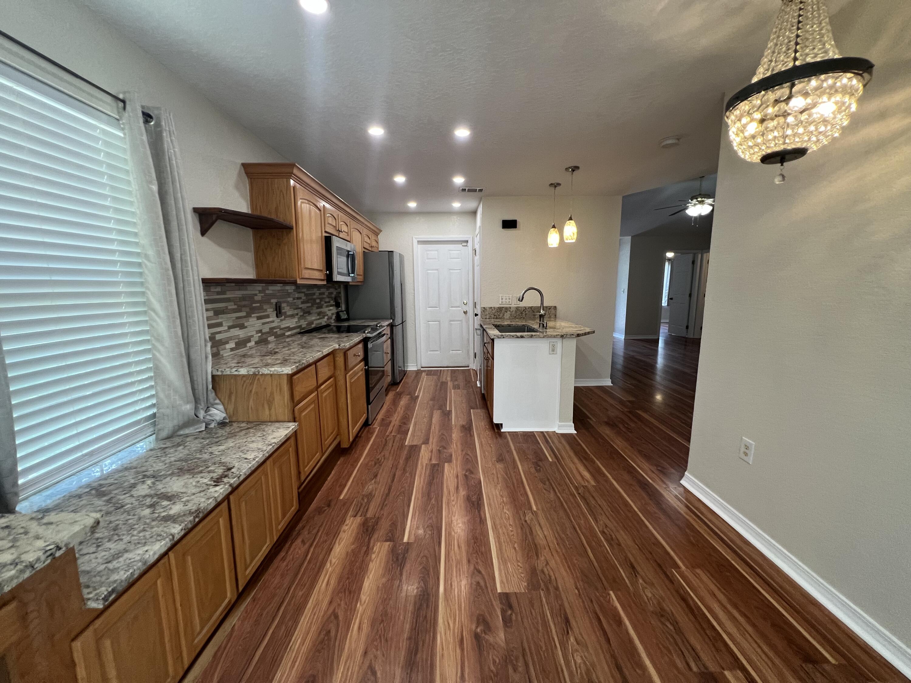 2864 Shoffner Avenue Crestview, FL 32539 - Photo 9 of 29 a view of a kitchen with kitchen island stainless steel appliances a sink and wooden floor