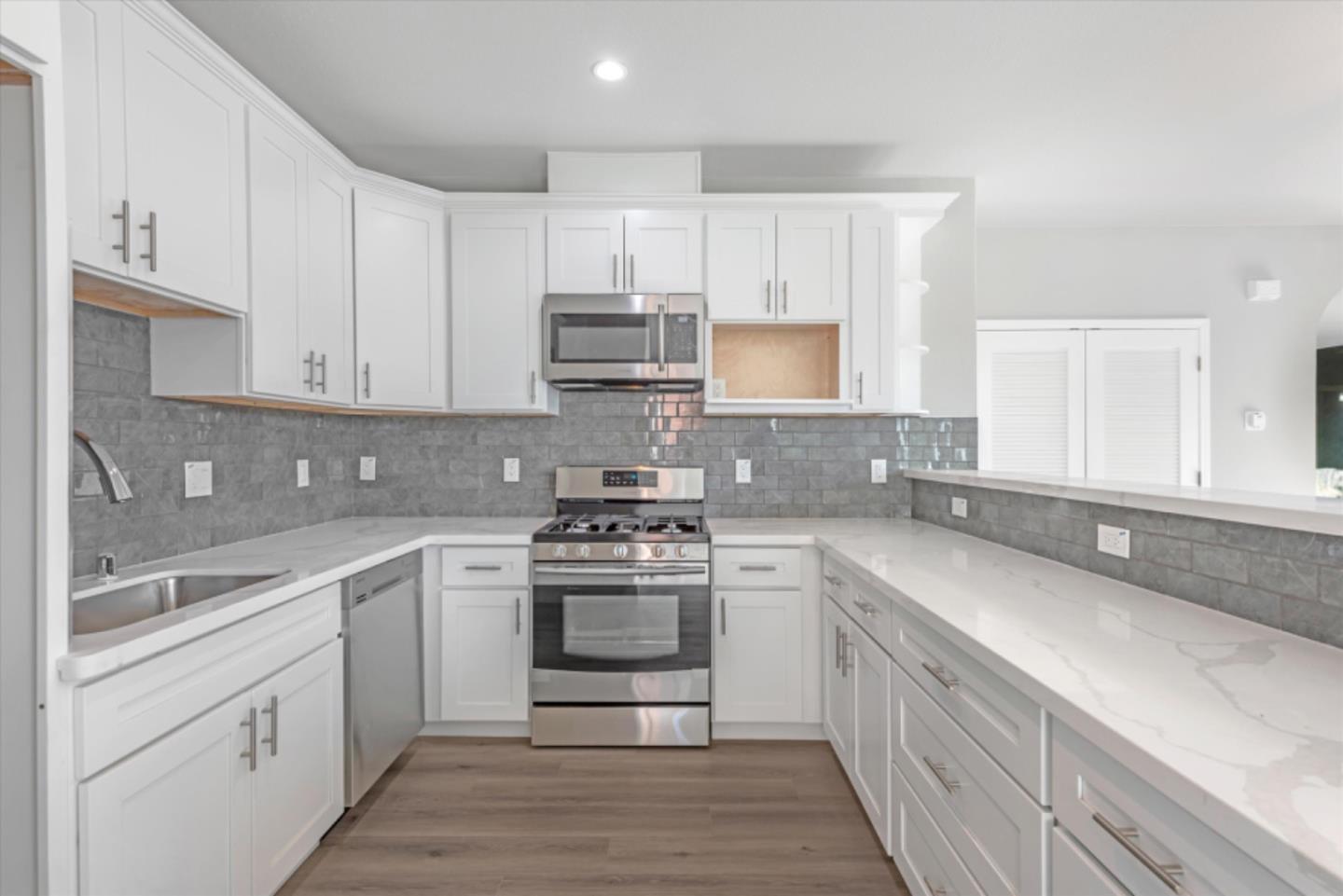 823 West A Street, Unit 2 Hayward, CA 94541 - Photo 3 of 8 a kitchen with stainless steel appliances granite countertop a sink and cabinets
