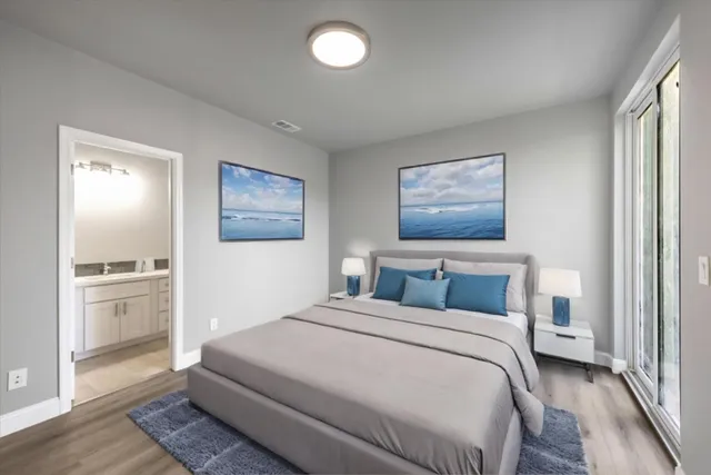 a bedroom with a large bed and a chandelier