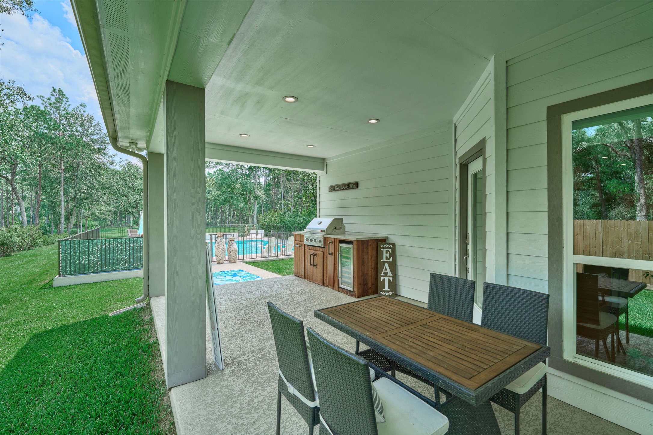 2218 Honea Egypt Road Magnolia, TX 77354 - Photo 14 of 50 Inviting covered patio with built-in outdoor grill and dining space.