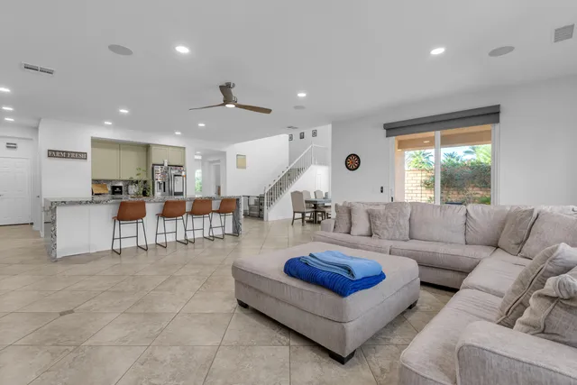 a living room with furniture and a ceiling fan
