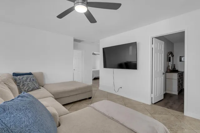 a bedroom with a bed and flat screen tv