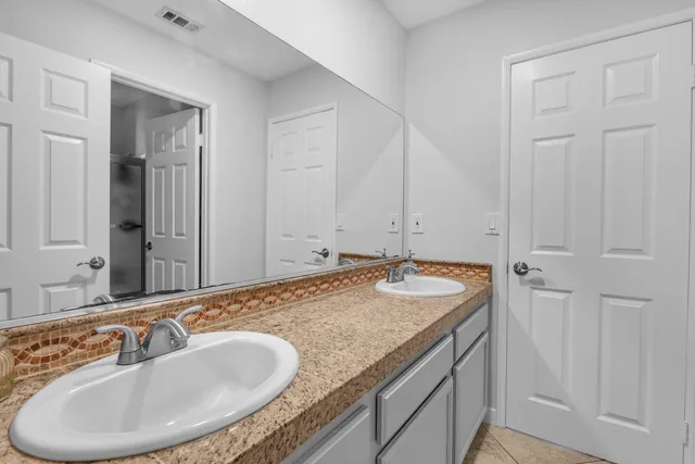 a bedroom with a bed and cabinets