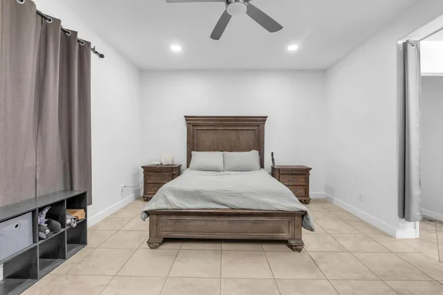 a view of a white house with a flower garden