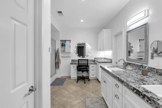 a view of a city with lots of residential buildings ocean and mountain view in back