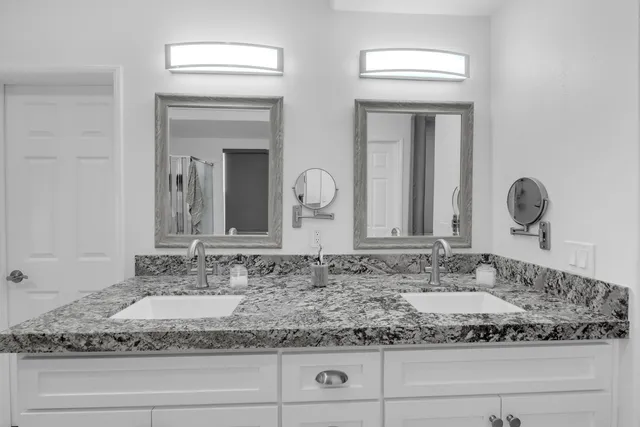 an aerial view of ocean and residential houses with outdoor space