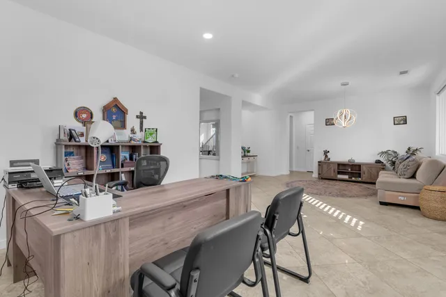 a large kitchen with stainless steel appliances kitchen island granite countertop a large counter top a stove a chimney a sink and a refrigerator