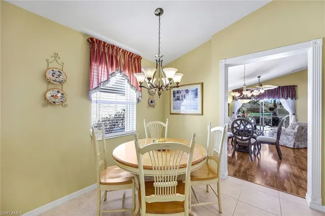 a view of a dining room with furniture wooden floor and a chandelier